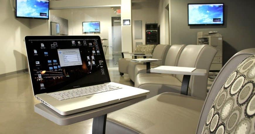 A laptop computer on a desk in a waiting room