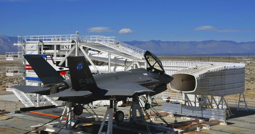 A military aircraft stationed on a platform within a hangar